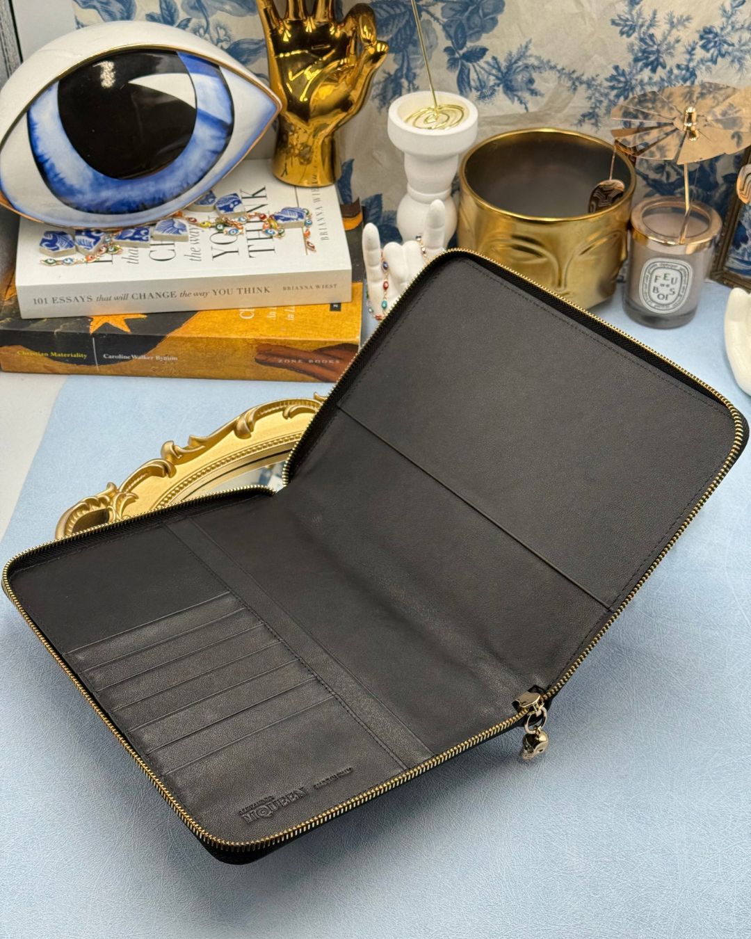 Interior of ALEXANDER McQUEEN Skull embossed black leather portfolio with gold-tone hardware