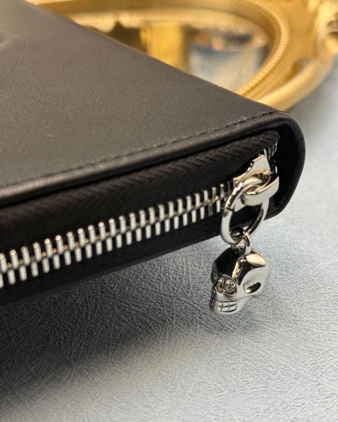 Crystal skull detail on ALEXANDER McQUEEN black leather portfolio