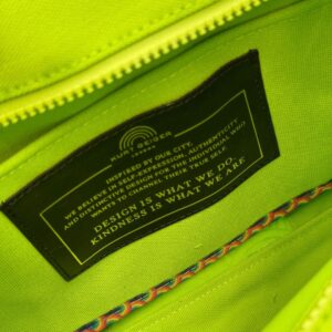 Interior label tag of KURT GEIGER LONDON Southbank Tote Bag in lime canvas with rainbow print