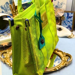 Side view of KURT GEIGER LONDON Southbank Tote Bag in lime canvas with rainbow print wide side poppers released